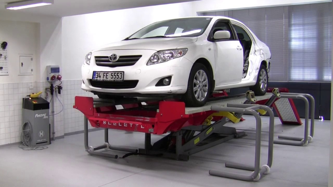 Toyota Corolla ready for Rear Fender pulling repair on Celette Rhone frame machine