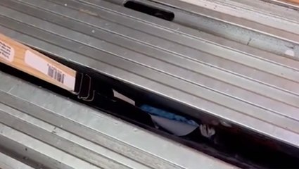 Retrieving A Phone Stuck In An Elevator Crack With A Stick And Tape
