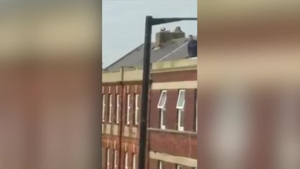 Man hurls tiles in roof stand-off