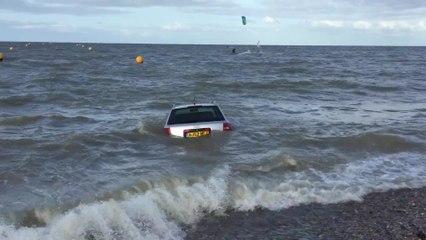 A car gets surrounded by the sea off the Isle of Sheppy.