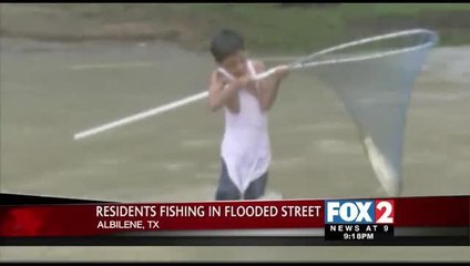 Texas Residents Fishing in Flooded Street