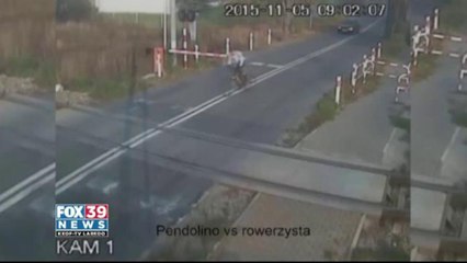 A cyclist in Poland merely inches away from getting hit by a train