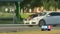 Caught on Camera: Man Drives Down Street with Woman on Hood