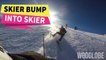 'Guy bumps into and knocks down inexperienced skier while sliding downhill '