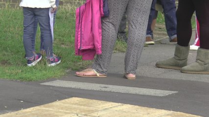 Teachers urge parents to social distance after crowds gather at the gates