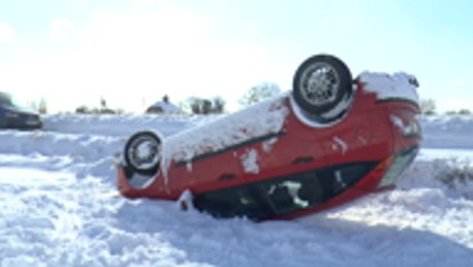 Car left upside down in snowy conditions
