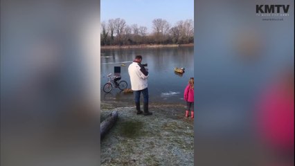 Man films children riding bikes on icy lake