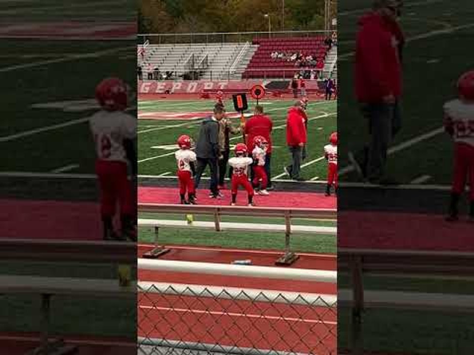 Peewee Football Player Grooves Away on the Sidelines