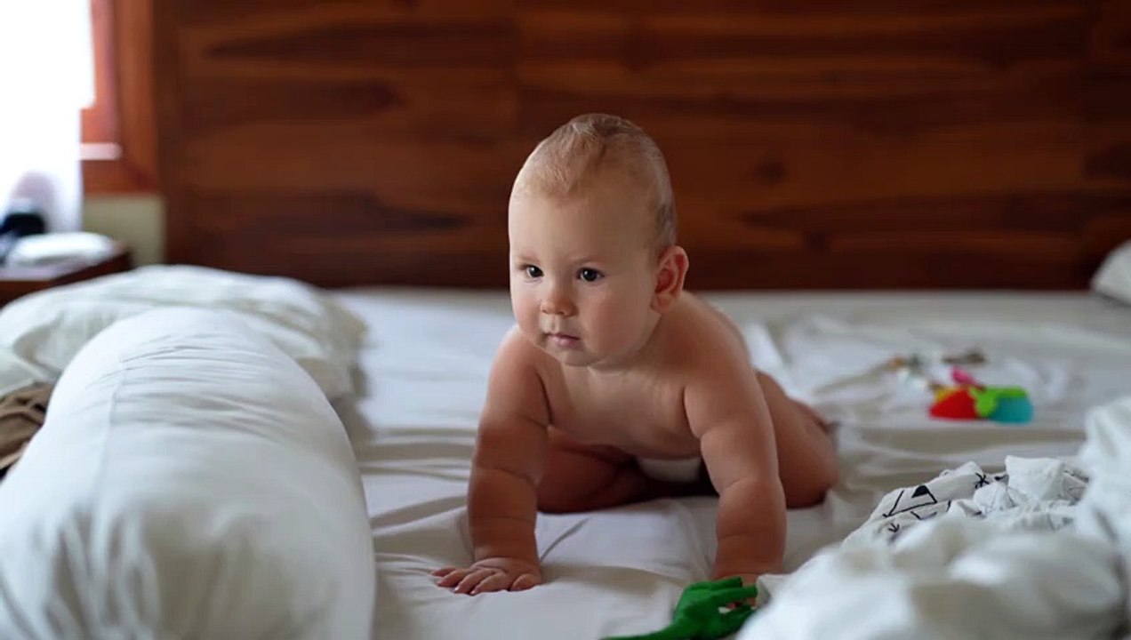 A Happy And Funny Baby On Bed