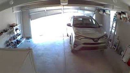 Car Backs into Garage Door Before It's Fully Open