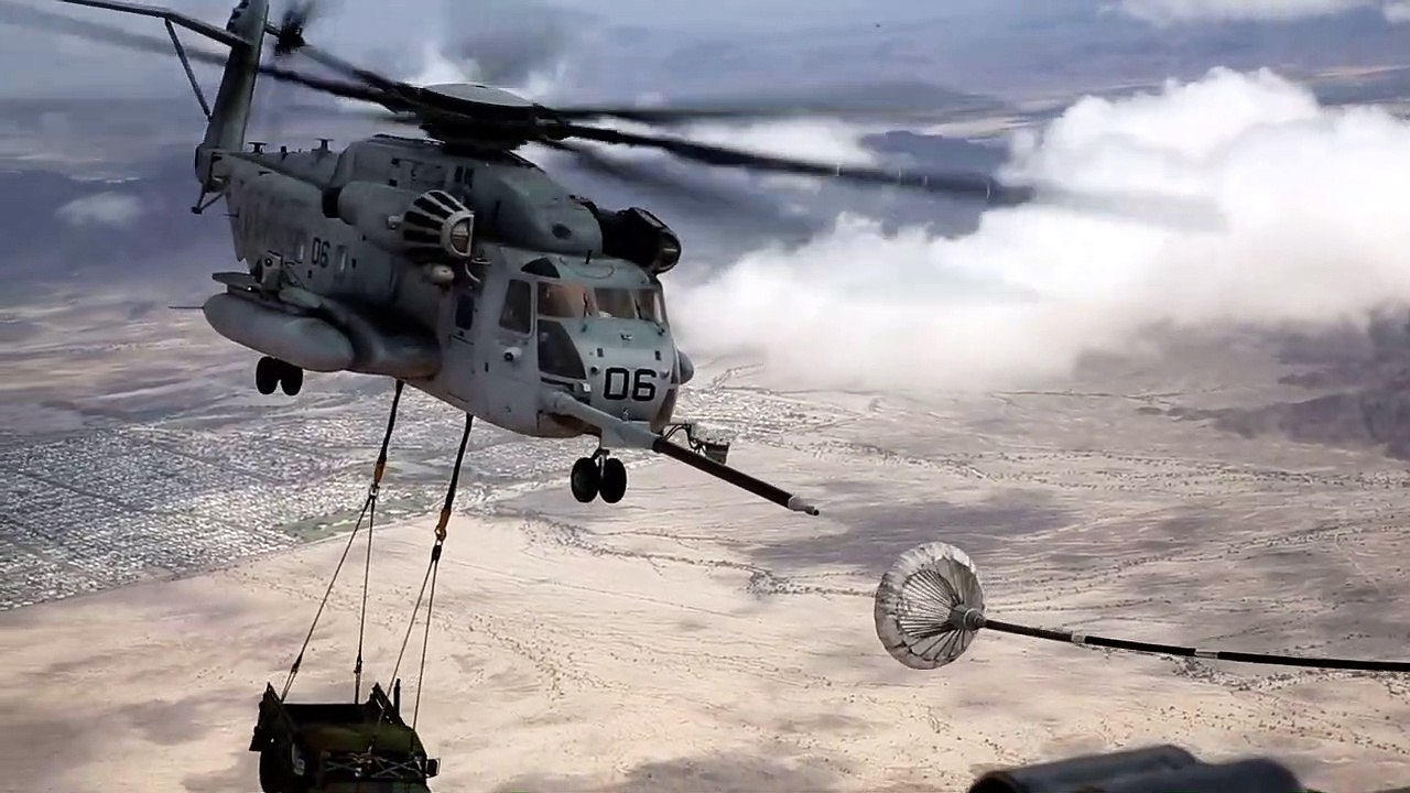 CH-53E Super Stallion helicopter sling loading a HUMVEE military vehicle