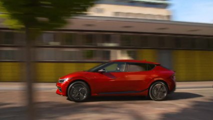 The new Kia EV6 in Runaway Red Driving in the city