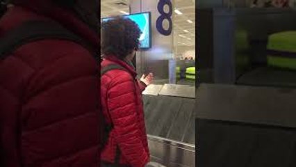 Man Appears to Direct Luggage at Barcelona Airport Baggage Claim