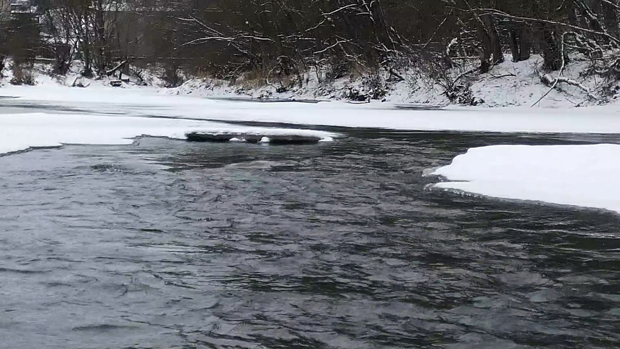 Stream of a frozen river in Romania