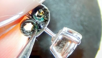 A jewelry specialist shows how diamond earrings are professionally deep cleaned