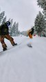 Snowboarders Splash Snow on Each Other While Riding Downhill