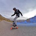 Guy Rides Freeboard With Blue-Colored Smoke Bomb