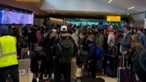 Crowds of passengers left stranded at Denver airport over flight disruptions caused by Omicron