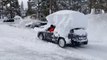 Guy Drives Car With Pile of Snow Accumulated Over its Top