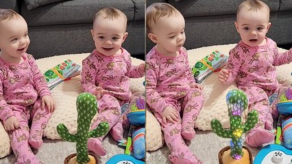 'Identical twins have a blast playing with 'mocking cactus' on their first Christmas '