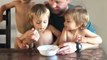 Grandpa Feeds Toddlers From His Cereal Bowl While Eating Breakfast