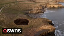 A huge sinkhole has appeared at a coastal beauty spot revealing a hidden underground beach