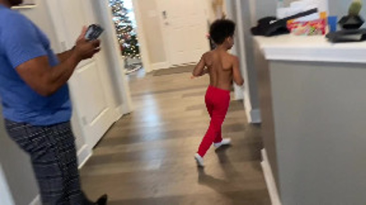 Son Listening to Dad is Oblivious to Dirt Bike Christmas Present