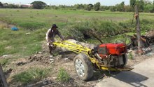 Thai farmer use irrigation water pump at rice field in Thailand