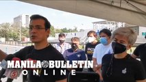 Mayor Isko Moreno and VM Honey Lacuna inspect the drive-thru vax site at the Quirino Grandstand