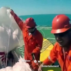 man parachuting on a moving ship