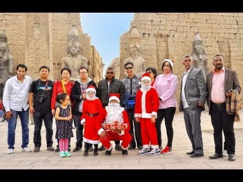 بابا نويل يوزع الهدايا الفرعونية والورود على السائحين بمعبد الأقصر