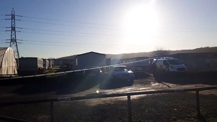 Police at the scene in Homefield Farm Road, near Dartford, after a man was found dead