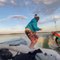 Surfer Warms Up For Surfing By Skipping Rope On Boat