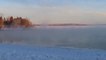 Person Watches Sea Smoke Rise on Lake