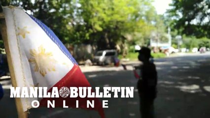 A vendor sells Philippine flags in downtown Davao City