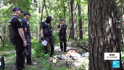 'In the woods, 10 kilometres from Bucha, freshly dug ground indicates a sinister discovery'