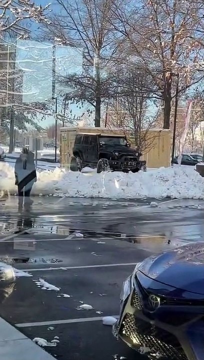 Jeep Trying to Cross Snowbank Gets Stuck
