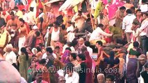 Pilgrims wait for turns to take a holy dip in river Ganges during Mahashivaratri festival