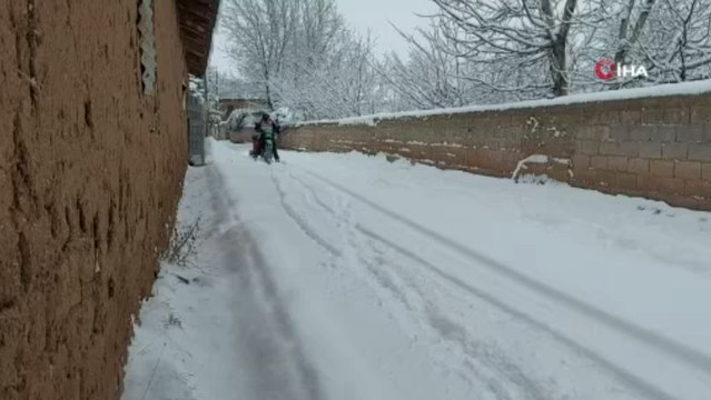 Motosiklete bağladığı kızaklarla çocukları karda eğlendirdi