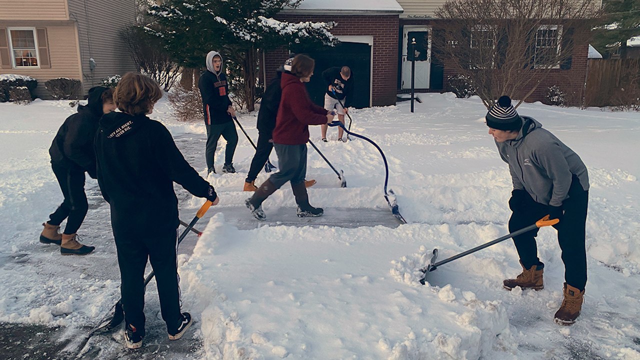 High School Football Team Shovels Snow For The...