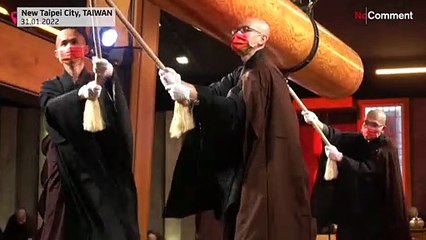 Monks ring temple bell for Lunar New Year