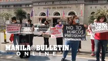 Protesters call for the Comelec to release their decision on the Marcos DQ case