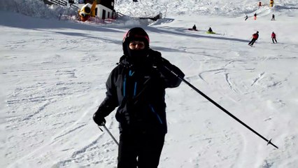 A Woman Skier is Passing By at Ski Slope