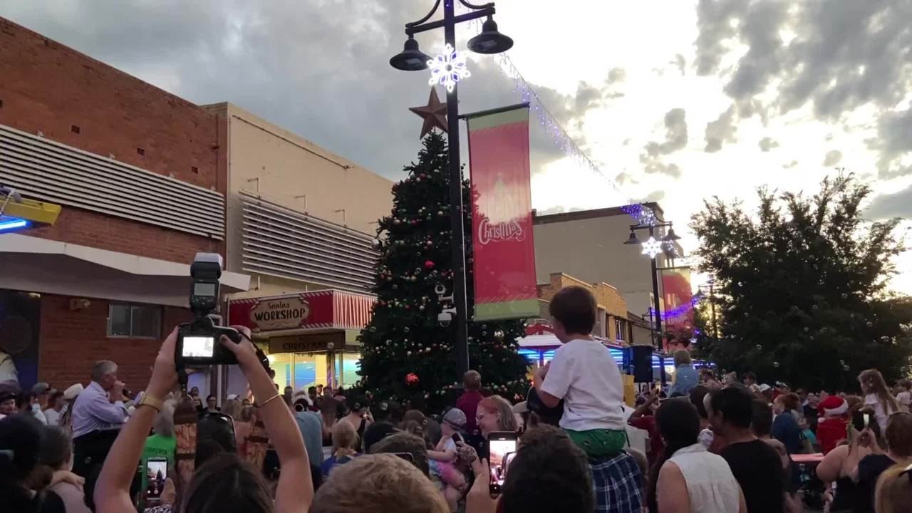 Santa Claus lights the Christmas tree December...