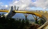 You Can Really Walk Across This Fantastical Golden Bridge Held Up By Two Enormous Hands