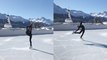 'Figure skater performs enchanting dance on ice rink backdropped by heavenly valley '