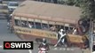 Bus spins out of control and flips onto its side - trapping and injuring 27 people