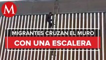 ¡Con una escalera! Captan a migrantes cruzando muro fronterizo hacia EU