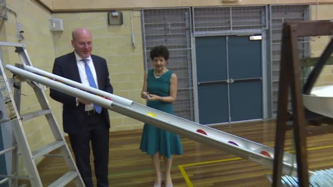 Lane Cove mayor Pam Palmer and MP  Trent Zimmerman use the rain machine