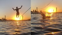 'Nature lover bravely walks a slackline above water at sunset *Visually Soothing*'